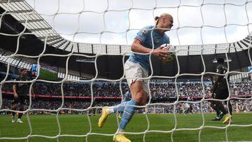 Manchester City's Norwegian striker Erling Haaland gathers the ball after Manchester City's Portuguese defender Joao Cancelo scored the team's first goal during the English Premier League football match between Manchester City and Southampton at the Etihad Stadium in Manchester, north west England, on October 8, 2022. - RESTRICTED TO EDITORIAL USE. No use with unauthorized audio, video, data, fixture lists, club/league logos or 'live' services. Online in-match use limited to 120 images. An additional 40 images may be used in extra time. No video emulation. Social media in-match use limited to 120 images. An additional 40 images may be used in extra time. No use in betting publications, games or single club/league/player publications. (Photo by Oli SCARFF / AFP) / RESTRICTED TO EDITORIAL USE. No use with unauthorized audio, video, data, fixture lists, club/league logos or 'live' services. Online in-match use limited to 120 images. An additional 40 images may be used in extra time. No video emulation. Social media in-match use limited to 120 images. An additional 40 images may be used in extra time. No use in betting publications, games or single club/league/player publications. / RESTRICTED TO EDITORIAL USE. No use with unauthorized audio, video, data, fixture lists, club/league logos or 'live' services. Online in-match use limited to 120 images. An additional 40 images may be used in extra time. No video emulation. Social media in-match use limited to 120 images. An additional 40 images may be used in extra time. No use in betting publications, games or single club/league/player publications. (Photo by OLI SCARFF/AFP via Getty Images)