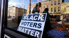 A sign encouraging Black people to vote sits in the window of a downtown storefront on November 1, 2020 in Racine, Wisconsin. 
