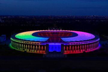 The Olympic stadium illuminated with rainbow colours, in Berlin.