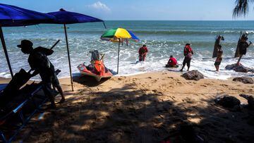 People enjoy at Cha-am Beach, amid the coranavirus disease outbreak, in Phetchaburi province, Thailand, December 25, 2021.
