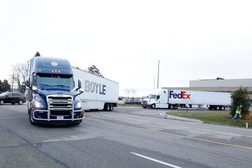 Trucks carrying the first shipment of the Covid-19 vaccine that is being escorted by the US Marshals Service, leave Pfizer's Global Supply facility in Kalamazoo, Michigan on 13 December 2020.