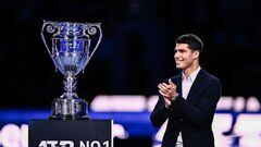 Spain's Carlos Alcaraz applauds as he receives the 2022 Year-End Number 1 trophy on November 16, 2022 during a ceremony within the ATP Finals tennis tournament in Turin, in which Alcaraz does not participate due to an injury. - Nineteen-year-old Carlos Alcaraz becomes the youngest ATP player ever to end the year ranked number one. (Photo by Marco BERTORELLO / AFP)