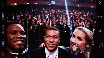 Former Ivorian forward Didier Drogba (L), Paris Saint-Germain&#039;s French forward Kylian Mbappe and French English tv host Sandy Heribert take a selfie picture during the Ballon d&#039;Or France Football 2019 ceremony at the Chatelet Theatre in Paris on
