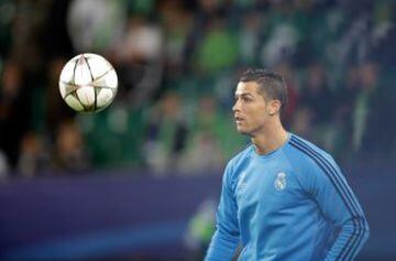 Real Madrid's Cristiano Ronaldo eyes the ball while warming up before the Champions League first leg quarter final soccer match between VfL Wolfsburg and Real Madrid
