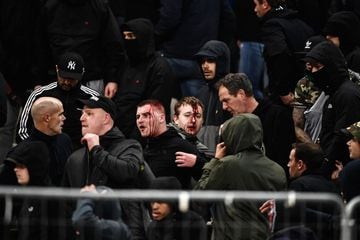 AEK Athens fans jumped onto the pitch and launched flares at the Ajax fans in the Champions League game in Greece on Tuesday night, causing police to intervene.