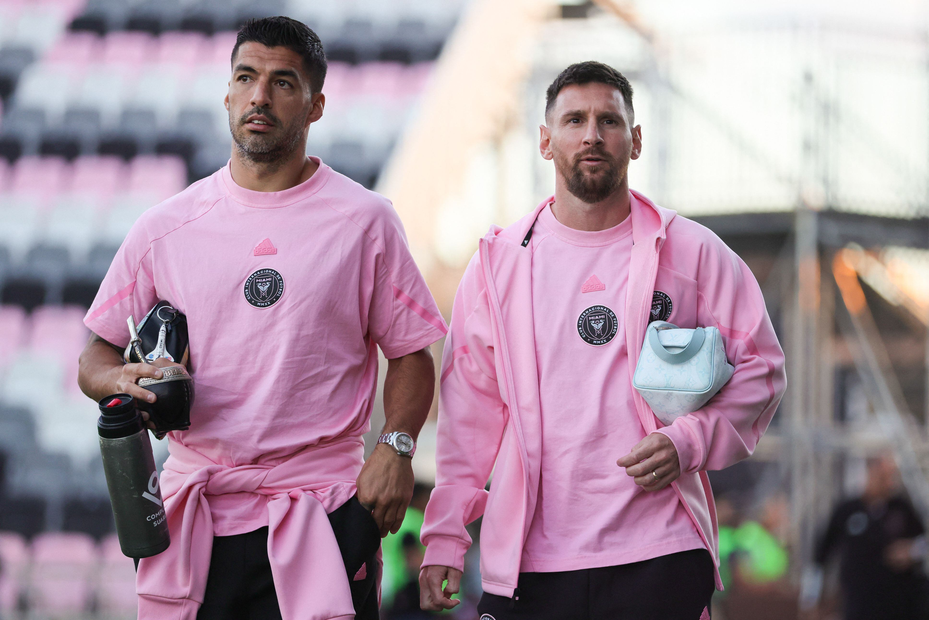 Luis Suarez alongside Lionel Messi.