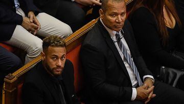 Paris Saint-Germain's Brazilian forward Neymar (L) and his father Brazilian former footballer Neymar Senior look on during the opening audience at the courthouse in Barcelona on October 17, 2022, on the first day of their trial. - With the World Cup barely a month away, Brazilian superstar Neymar goes on trial in Spain over alleged irregularities in his transfer to Barcelona nearly a decade ago. The 30-year-old was acompanied by his parents, who are also in the dock on corruption-related charges over his 2013 transfer from the Brazilian club Santos. (Photo by Josep LAGO / AFP)