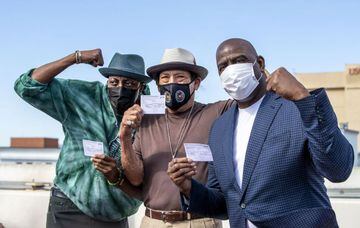 US actors Arsenio Hall and Danny Trejo, and former NBA player Magic Johnson pose for a photo after they all got vaccine shots on the rooftop of a parking structure as a part of a vaccination awareness event at USC in Los Angeles, California, 24 March 2021