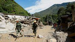 Colombia National Police rescue officers walk at an area affected by a landslide which left several casualties and others injured, in Quetame, Colombia, July 18, 2023. REUTERS/Santiago Molina NO RESALES. NO ARCHIVES