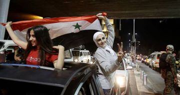 Syrian football fans celebrate in the streets of Damascus after the FIFA World Cup 2018 qualification football match between Iran and Syria ended in a draw at 2-2 on September 5, 2017