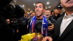 This file photo taken on January 19, 2017 shows Argentine striker Carlos Tevez making his way through the arrivals halls at Shanghai Pudong International Airport in Shanghai.    The Chinese Super League will take another step towards global recognition when it returns on March 3, 2017, boasting the world&#039;s richest players and a growing audience including live broadcasts in Britain. When Argentina&#039;s Carlos Tevez makes his league debut for Shanghai Shenhua, fans from Liaoning to Liverpool can tune in to see what can be bought with reported wages of 768,000 USD a week. / AFP PHOTO / STR / China OUT