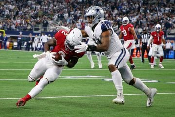 The Arizona Cardinals' Chase Edmonds (left) is tackled by the Dallas Cowboys' Micah Parsons.