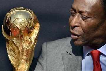 Brazilian football legend Pele looks at the World Cup trophy during a FIFA in Paris in 2014.