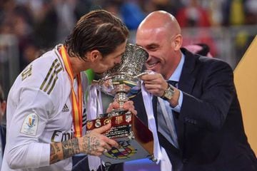 Real Madrid's Spanish defender Sergio Ramos kisses the trophy.