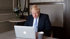 Britain&#039;s Prime Minister Boris Johnson poses for a photograph as he prepares his speech on a laptop in his hotel room, on the third day of the annual Conservative Party Conference in Manchester, northwest England, on October 5, 2021, ahead of his key