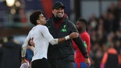 Liverpool's German manager Jurgen Klopp (C) embraces Liverpool's Colombian midfielder #07 Luis Diaz (L) as he celebrates on the pitch after the English Premier League football match between Crystal Palace and Liverpool at Selhurst Park in south London on December 9, 2023. Liverpool won the game 2-1. (Photo by Adrian DENNIS / AFP) / RESTRICTED TO EDITORIAL USE. No use with unauthorized audio, video, data, fixture lists, club/league logos or 'live' services. Online in-match use limited to 120 images. An additional 40 images may be used in extra time. No video emulation. Social media in-match use limited to 120 images. An additional 40 images may be used in extra time. No use in betting publications, games or single club/league/player publications. / 