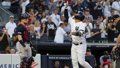NEW YORK, NEW YORK - AUGUST 02: Gleyber Torres #25 of the New York Yankees celebrates his first inning grand slam home run at home plate as Christian Vazquez #7 of the Boston Red Sox looks on at Yankee Stadium on August 02, 2019 in New York City.   Jim Mc
