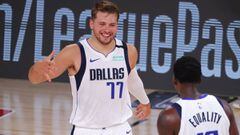 LAKE BUENA VISTA, FLORIDA - AUGUST 08: Luka Doncic #77 of the Dallas Mavericks celebrates a three point basket with teammate Dorian Finney-Smith #10 during the fourth quarter against the Milwaukee Bucks at The Arena at ESPN Wide World Of Sports Complex on