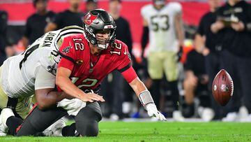 TAMPA, FLORIDA - DECEMBER 19: Tom Brady #12 of the Tampa Bay Buccaneers fumbles the ball as he is hit by Cameron Jordan #94 of the New Orleans Saints during the 4th quarter of the game at Raymond James Stadium on December 19, 2021 in Tampa, Florida.   Jul