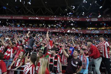 Athletic Club fans throw fake money in their air during their team's defeat to Barcelona.  