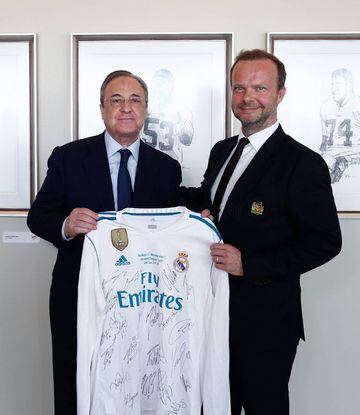 Florentino Pérez, presidente del Real Madrid, entrega a Ed Woodward, CEO del Manchester United, una camiseta del Real Madrid firmada por los jugadores.