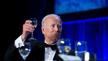 President Joe Biden raises his glass for a toast during the annual White House Correspondents Association Dinner.