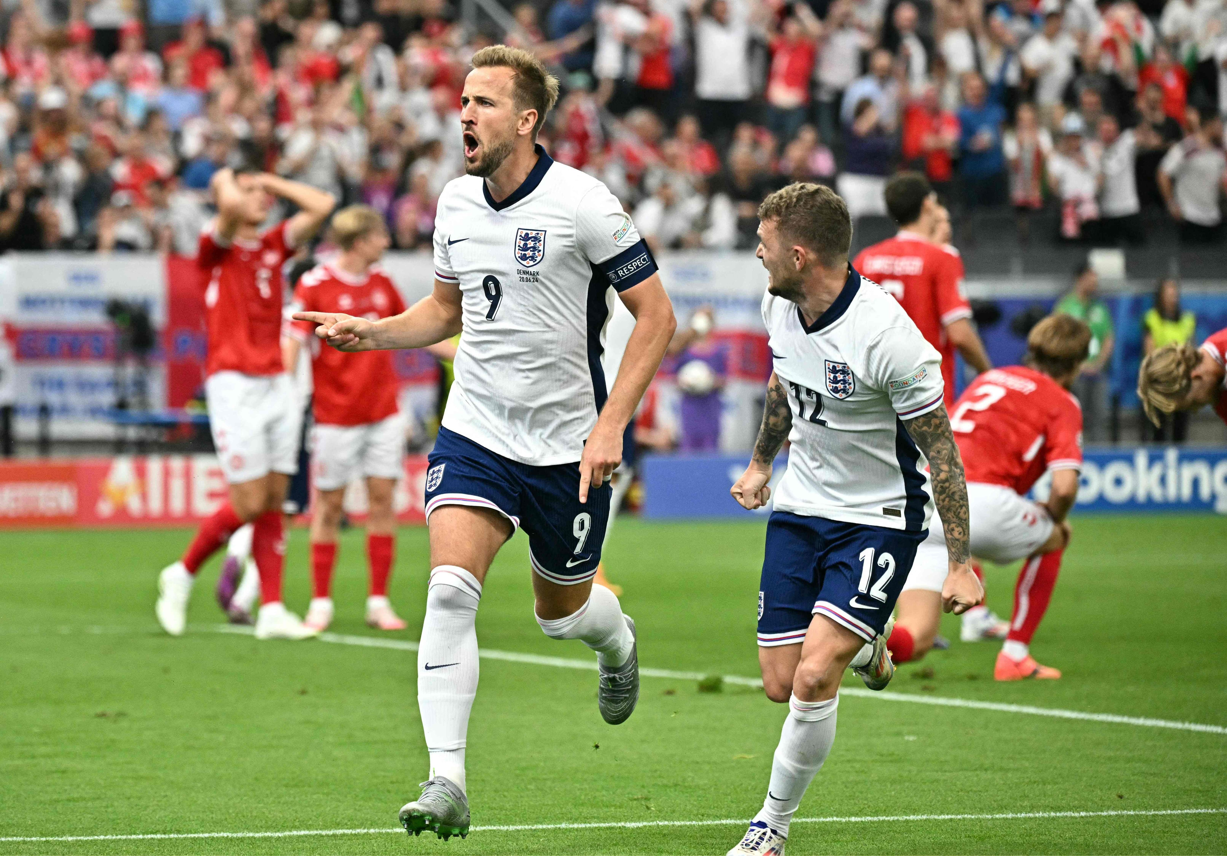 England's forward #09 Harry Kane celebrates scoring his team's first goal next to England's defender #12 Kieran Trippier (R) during the UEFA Euro 2024 Group C football match between Denmark and England at the Frankfurt Arena in Frankfurt am Main on June 20, 2024. (Photo by JAVIER SORIANO / AFP)