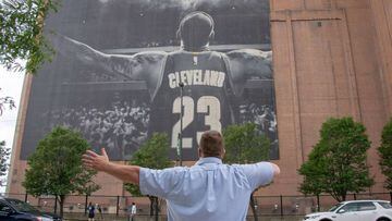 CLEVELAND, OH - JULY 3: A man poses as workers remove the Nike LeBron James banner from the Sherwin-Williams building near Quicken Loans Arena on July 3, 2018 in Cleveland, Ohio. NOTE TO USER: User expressly acknowledges and agrees that, by downloading an