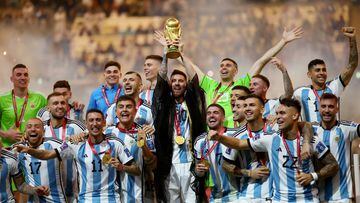 Lionel Messi celebrates with the trophy and teammates after winning the World Cup.