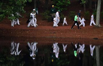 Trevor Immelman of South Africa, Louis Oosthuizen of South Africa, Charl Schwartzel of South Africa and children walk during the Par 3 Contest