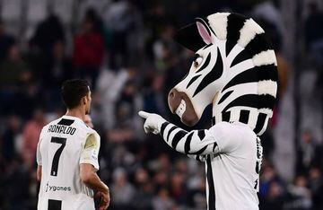 Juventus' Portuguese forward Cristiano Ronaldo walks next to the Juventus Mascotte at the end of the Italian Serie A football match between Juventus and Bologna