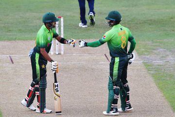 Pakistan's Babar Azam (L) and Muhammad Hafeez gesture during the first one day international (ODI) cricket match between Sri Lanka and Pakistan.