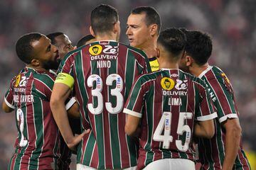 Colombian referee Wilmar Roldan (3-R) argues with players of Fluminense during the Copa Libertadores group stage second leg football match