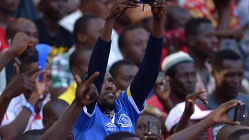 An Everton supporter takes a picture before a friendly between Everton and Kenya's Gor Mahia.