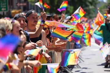 NEW YORK, NEW YORK - JUNE 26: People wave Pride flags as they watch the New York City Pride Parade on Fifth Avenue on June 26, 2022 in in New York City. The 53rd annual NYC Pride March is the marquee event in NYC during LGBTQ+ Pride month in June. The parade has been an annual tradition since it was first held in 1970 to observe the one-year anniversary of the Stonewall Uprising in Greenwich Village. (Photo by Michael M. Santiago/Getty Images)