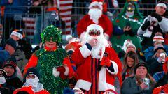 Fans in Christmas costumes watch from the stands