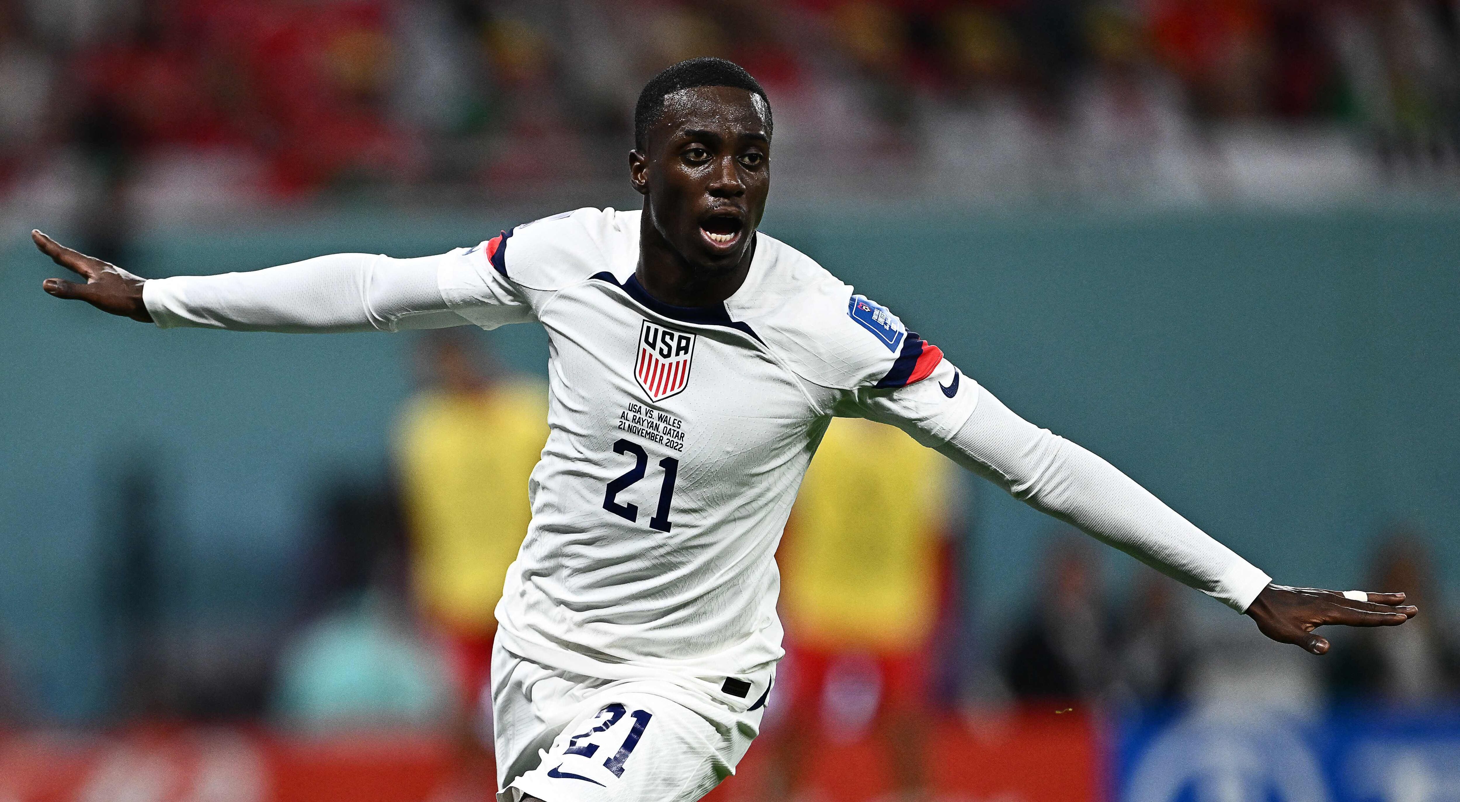 USA's forward #21 Timothy Weah celebrates scoring his team's first goal during the Qatar 2022 World Cup Group B football match between USA and Wales at the Ahmad Bin Ali Stadium in Al-Rayyan, west of Doha on November 21, 2022. (Photo by Jewel SAMAD / AFP)