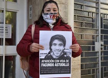 Photo released by Telam news agency displaying Argentinian Cristina Castro holding a banner with the portrait of her son Facundo Astudillo demanding for his appearance in Bahia Blanca, Buenos Aires province, Argentina, on July 14, 2020. - Forensic experts determined on September 2, 2020 that a corpse found in a rural area of the Buenos Aires province belongs to Facundo Astudilo, 22, who was seen for the last time on April 30 at a police checkpoint, where he was arrested for circulating amid a compulsory lockdown imposed by the government against the spread of the new coronavirus, and whose disappearance had been denounced by his family. (Photo by HORACIO CULACIATTI / TELAM / AFP) / - Argentina OUT / RESTRICTED TO EDITORIAL USE - MANDATORY CREDIT AFP PHOTO / TELAM / HORACIO CULACIATTI - NO MARKETING NO ADVERTISING CAMPAIGNS -DISTRIBUTED AS A SERVICE TO CLIENTS