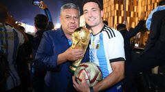 LUSAIL CITY, QATAR - DECEMBER 18: Lionel Scaloni, Head Coach of Argentina, celebrates with Claudio Tapia, President of the Argentine Football Association, after winning the FIFA World Cup on an open top bus outside the stadium during the FIFA World Cup Qatar 2022 Final match between Argentina and France at Lusail Stadium on December 18, 2022 in Lusail City, Qatar. (Photo by Michael Regan - FIFA/FIFA via Getty Images)