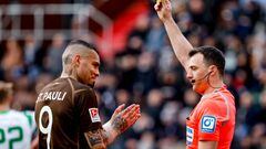 11 March 2023, Hamburg: Soccer, 2. Bundesliga, FC St. Pauli - SpVgg Greuther Fürth, Matchday 24, Millerntor-Stadion. Referee Felix Zwayer (r) shows Pauli's Maurides the yellow card. Photo: Axel Heimken/dpa - IMPORTANT NOTE: In accordance with the requirements of the DFL Deutsche Fußball Liga and the DFB Deutscher Fußball-Bund, it is prohibited to use or have used photographs taken in the stadium and/or of the match in the form of sequence pictures and/or video-like photo series. (Photo by Axel Heimken/picture alliance via Getty Images)