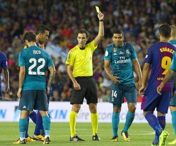 Referee Ricardo de Burgos Bengoetxea books Casemiro for a foul on Messi.