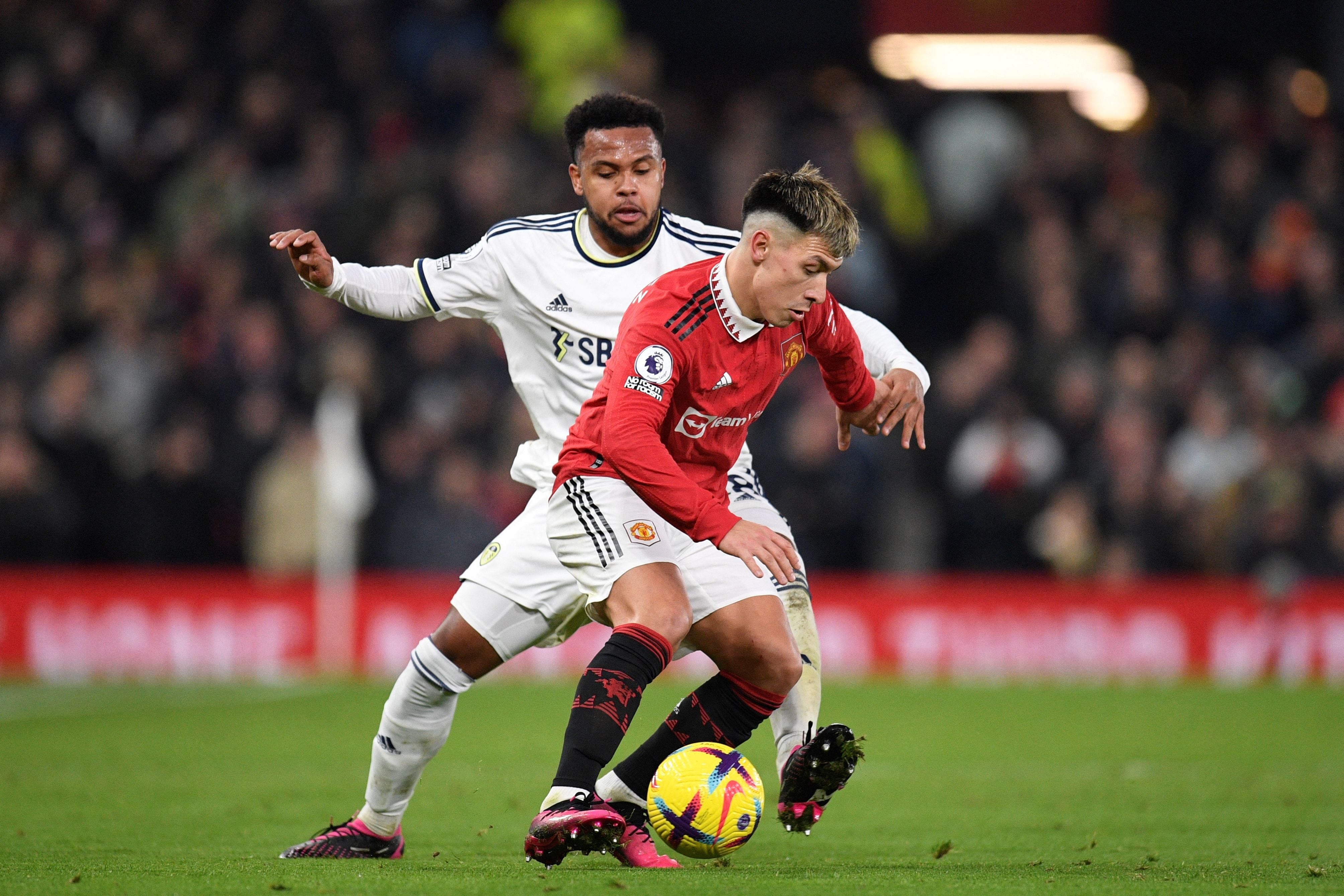 Leeds United's US midfielder Weston McKennie (rear) fights for the ball with Manchester United's Argentinian defender Lisandro Martinez (R) during the English Premier League football match between Manchester United and Leeds United at Old Trafford in Manchester, north west England, on February  8, 2023. (Photo by Oli SCARFF / AFP) / RESTRICTED TO EDITORIAL USE. No use with unauthorized audio, video, data, fixture lists, club/league logos or 'live' services. Online in-match use limited to 120 images. An additional 40 images may be used in extra time. No video emulation. Social media in-match use limited to 120 images. An additional 40 images may be used in extra time. No use in betting publications, games or single club/league/player publications. / 