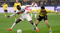 Paris Saint-Germain's French forward #23 Randal Kolo Muani (L) and Dortmund's Algerian defender #05 Ramy Bensebaini vie for the ball during the UEFA Champions League group F football match between BVB Borussia Dortmund and Paris Saint-Germain in Dortmund, western Germany, on December 13, 2023. (Photo by FRANCK FIFE / AFP)