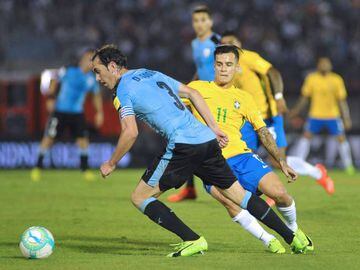 Uruguay's Diego Godin vies for the ball with Brazil's midfielder Philippe Coutinho.