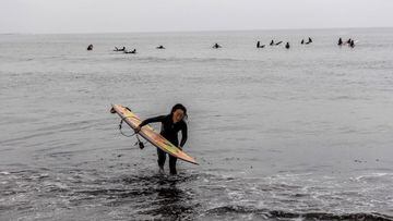 ICHINOMIYA, JAPAN - JULY 06: A surfer leaves the water at Tsurigasaki Beach, the Tokyo Olympics surfing venue, on July 6, 2021 in Ichinomiya, Japan. Surfing is making its debut at the Tokyo 2020 Olympics and will take place on Japans Pacific coast. (Photo