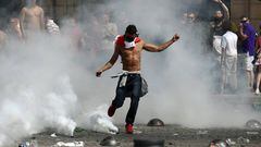 An England fan kicks a tear gas canister as fans clash with police ahead of the game against Russia later today on June 11, 2016 in Marseille, France. Football fans from around Europe have descended on France for the UEFA Euro 2016 football tournament.