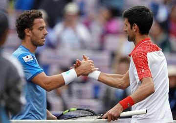 Novak Djokovic shakes hands with Marco Cecchinato after the match