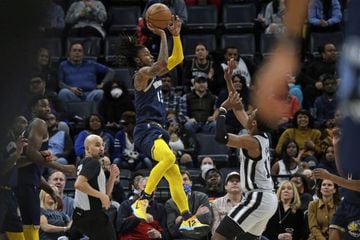 Feb 28, 2022; Memphis, Tennessee, USA; Memphis Grizzles guard Ja Morant (12) shoots with 0.4 seconds left in the first half against the San Antonio Spurs at FedExForum. Mandatory Credit: Petre Thomas-USA TODAY Sports