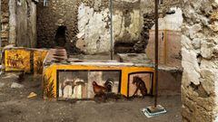 This picture released on December 26, 2020 by the Pompei Press Office shows a thermopolium, a sort of street &quot;fast-food&quot; counter in ancient Rome, that has been unearthed in Pompei, decorated with polychrome motifs and in an exceptional state of 