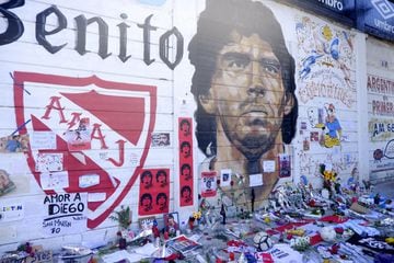 Fans place offerings to late Diego Maradona in front of mural outside Argentinos Juniors' Stadium Diego Maradona in Buenos Aires, Argentina.